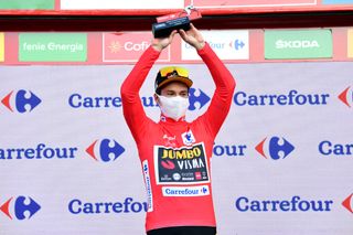 SUANCES SPAIN OCTOBER 30 Podium Primoz Roglic of Slovenia and Team Jumbo Visma Red Leader Jersey Celebration Mask Covid safety measures Trophy during the 75th Tour of Spain 2020 Stage 10 a 185km stage from Castro Urdiales to Suances lavuelta LaVuelta20 La Vuelta on October 30 2020 in Suances Spain Photo by Justin SetterfieldGetty Images