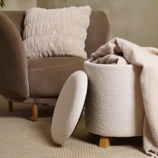 cream boucle ottoman stool with cream throw