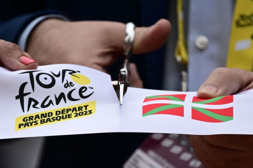The start line ribbon is cut at the start of the 1st stage of the 110th edition of the Tour de France cycling race 182 km departing and finishing in Bilbao in northern Spain on July 1 2023 Photo by Marco BERTORELLO AFP Photo by MARCO BERTORELLOAFP via Getty Images