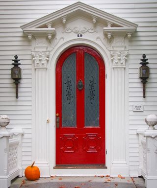 Red front door with pumpkin - Craig Tidball on Unsplash