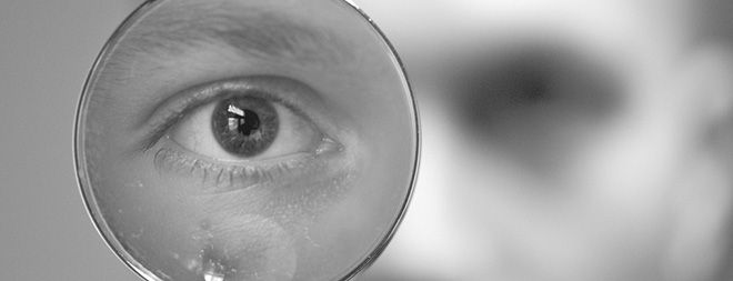 man looking through eye glass