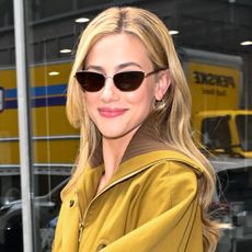Lili Reinhart wears an aviator jacket with flared jeans