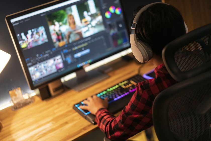 someone with headphones on doing video production