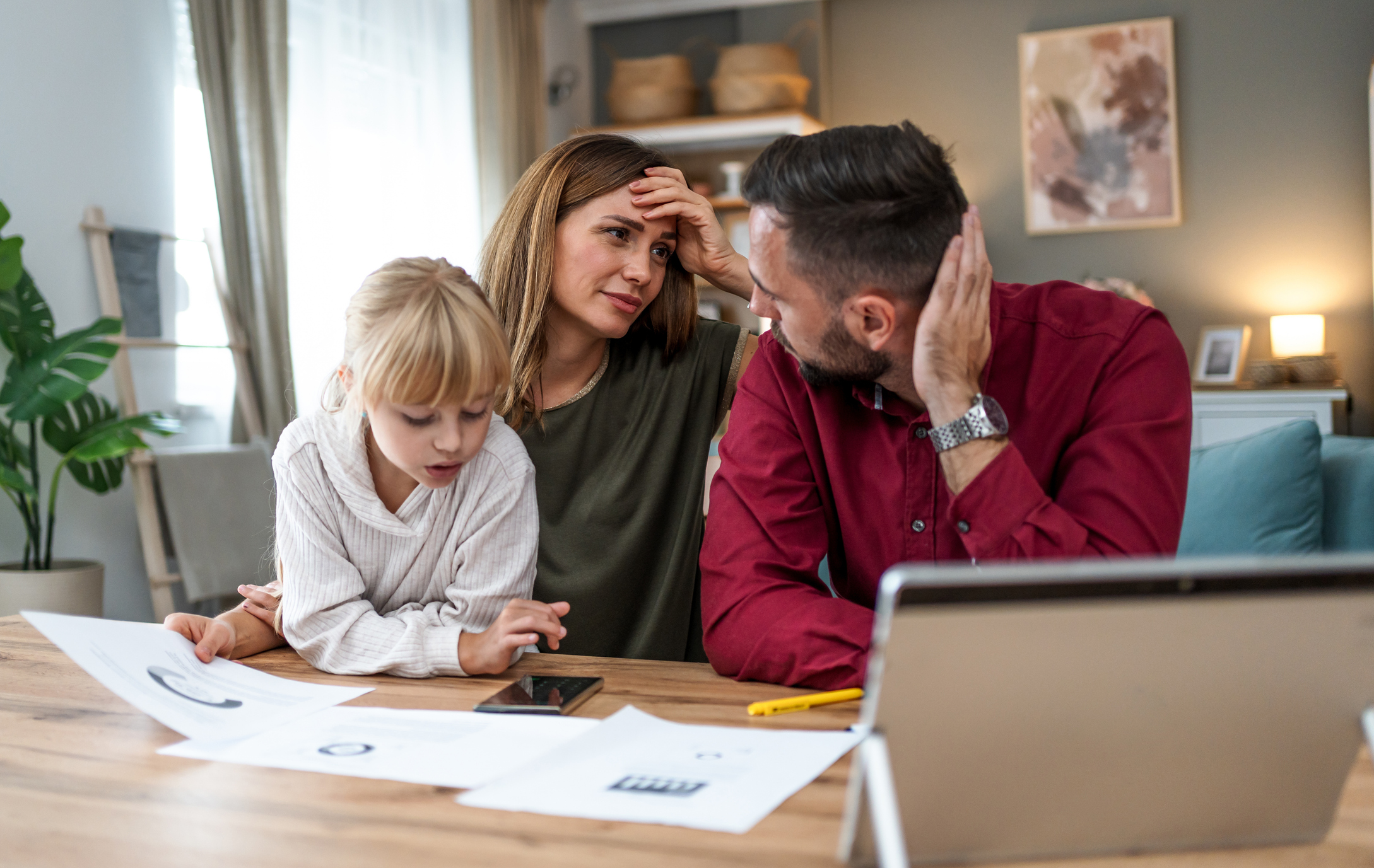 Young family with a daughter feeling distressed managing finances, paying bills and taxes