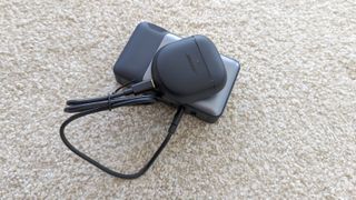 The Bose QuietComfort Earbuds 2 being charged via portable power bank