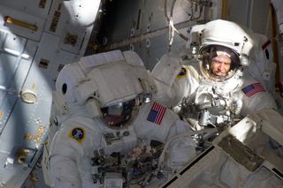 With components of the International Space Station in the view, NASA astronauts Andrew Feustel (right) and Michael Fincke are pictured during the STS-134 mission's third spacewalk on May 25, 2011.