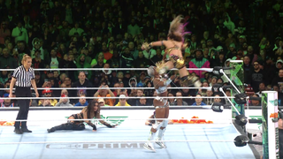 kairi sane jumps off the ropes onto jade cargill during their wrestlemania tag team match