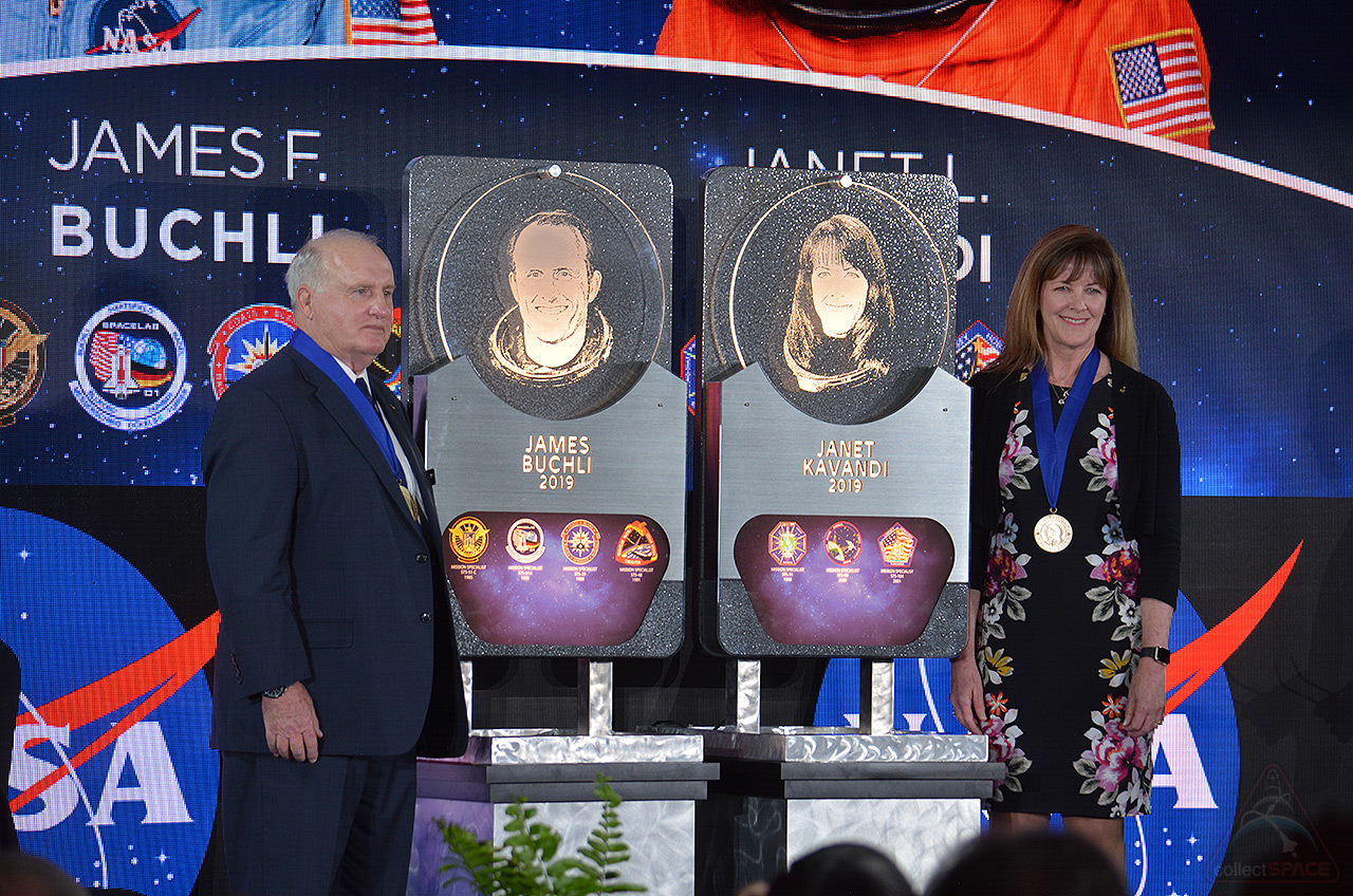 Astronauts Jim Buchli and Janet Kavandi were inducted into the U.S. Astronaut Hall of Fame during a ceremony on Saturday, April 6, 2019, under the display of the retired space shuttle Atlantis at NASA's Kennedy Space Center Visitor Complex in Florida. They unveiled their plaques, which will be placed in the Hall of Fame at the visitor complex.