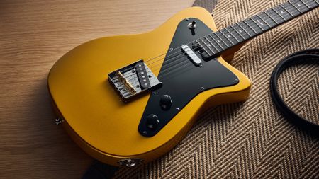 A Baum Guitars Verve electric guitar lying on a rug
