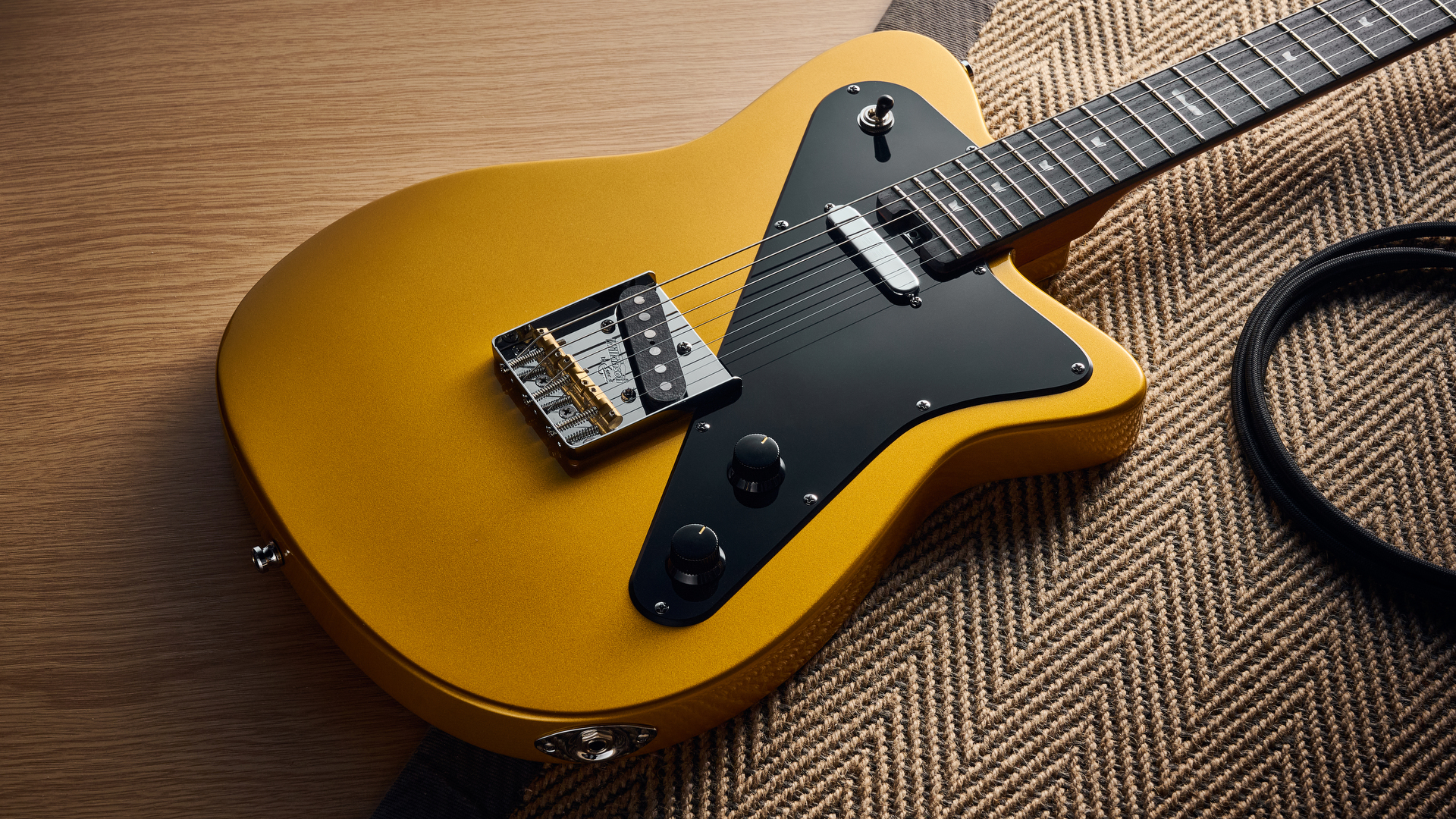 A Baum Guitars Verve electric guitar lying on a rug