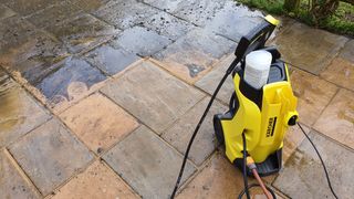 The Kärcher K4 Full Control Home Pressure Washer being used to clean a patio