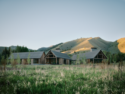 Three Barns by Field Architecture, a rural american home designed to look like a collection of old wooden barns