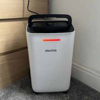 The ElectriQ dehumidifier with its humidity indicator light lit up red