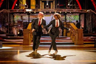 Bill Bailey and Oti Mabuse dancing in suits