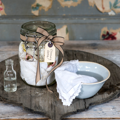 Cleaning cloth stored in glass kilner jar, white vinegar.