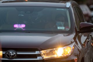 A Lyft driver wearing a mask waits for a customer as the city continues Phase 4 of re-opening following restrictions imposed to slow the spread of coronavirus on September 16, 2020 in New York City.