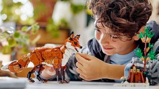 Kid playing with Lego Creator woodland Fox kit