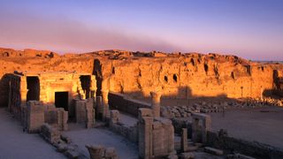 Sunrise starts to awaken the ruins of the small temple in front of the already lit grander remains of the Horus Temple.
