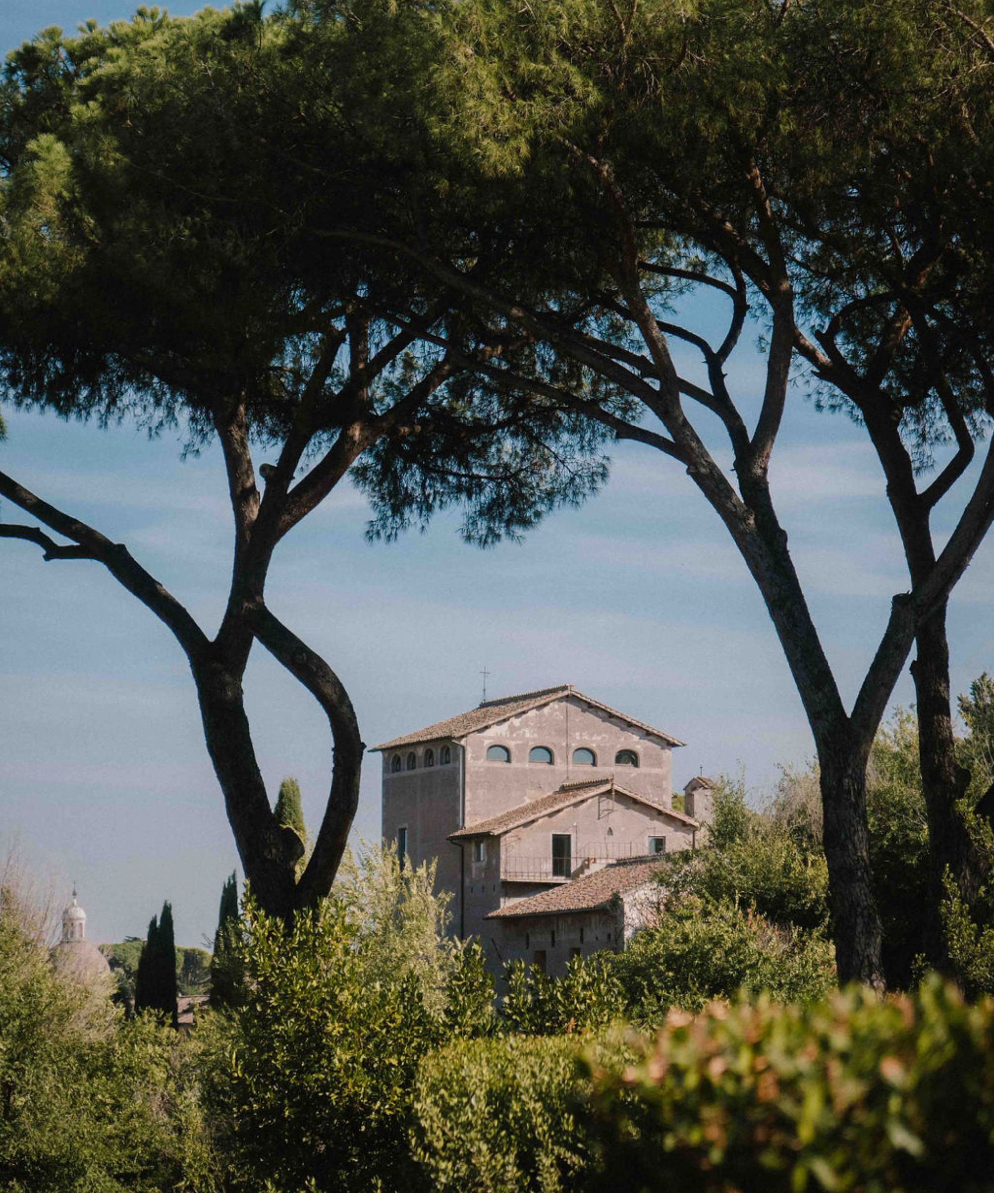 Image of Italian building surrounded by trees and greenery