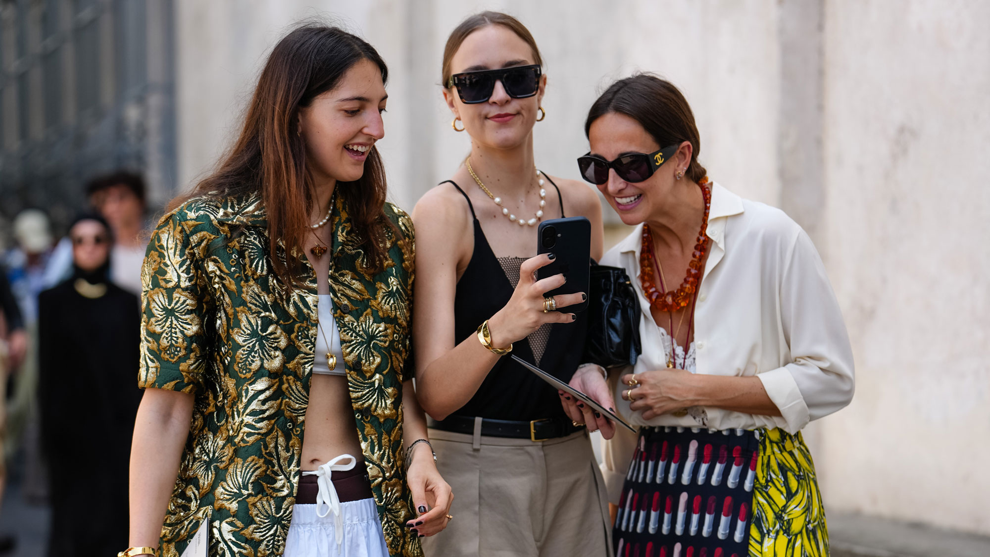 a group of women looking at a phone