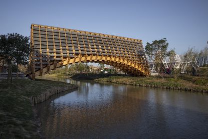 the finest new bridge design includes this timber bridge in china called Timber Bridge in Gulou Waterfront