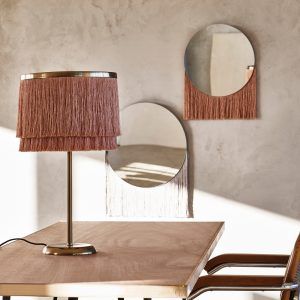 fringe table lamp with wooden table and chair