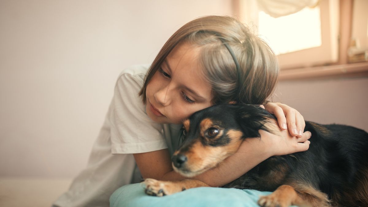 Child hugging dog