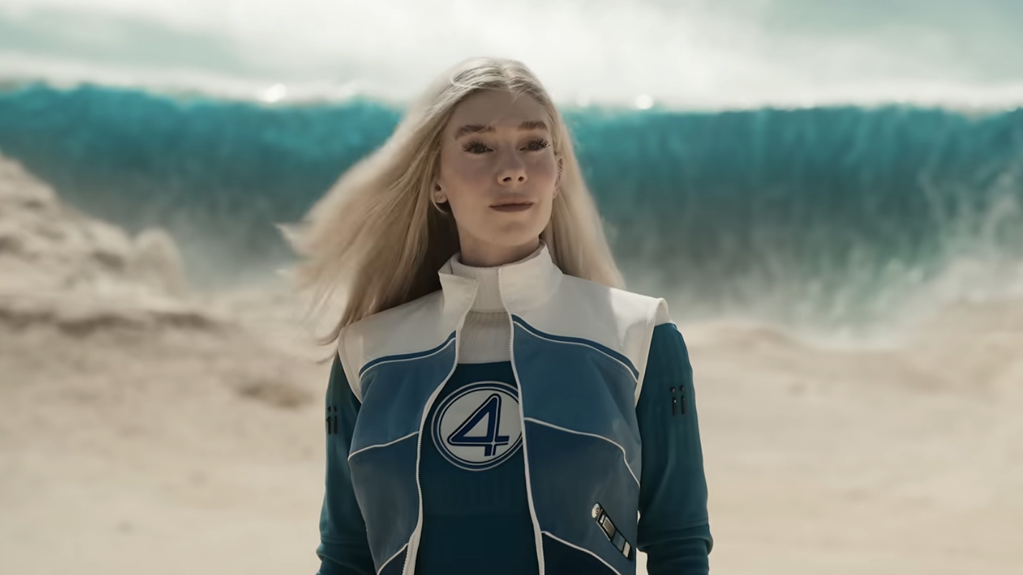 Sue Storm with a wave behind her in the Doomsday trailer. 