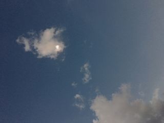 Totality begins while obscured by a cloud.