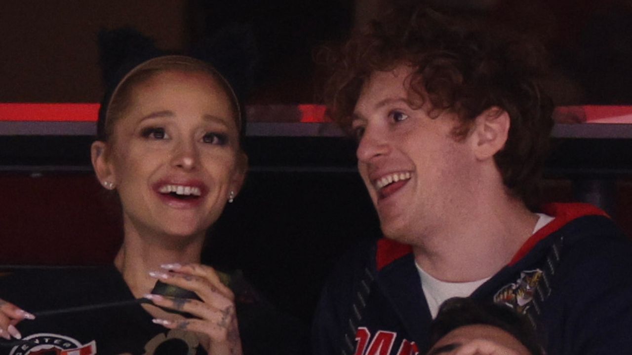 Ariana Grande and Ethan Slater laugh while wearing game shirts during Game One of the 2024 Stanley Cup Final between the Florida Panthers and the Edmonton Oilers in Florida on June 08, 2024