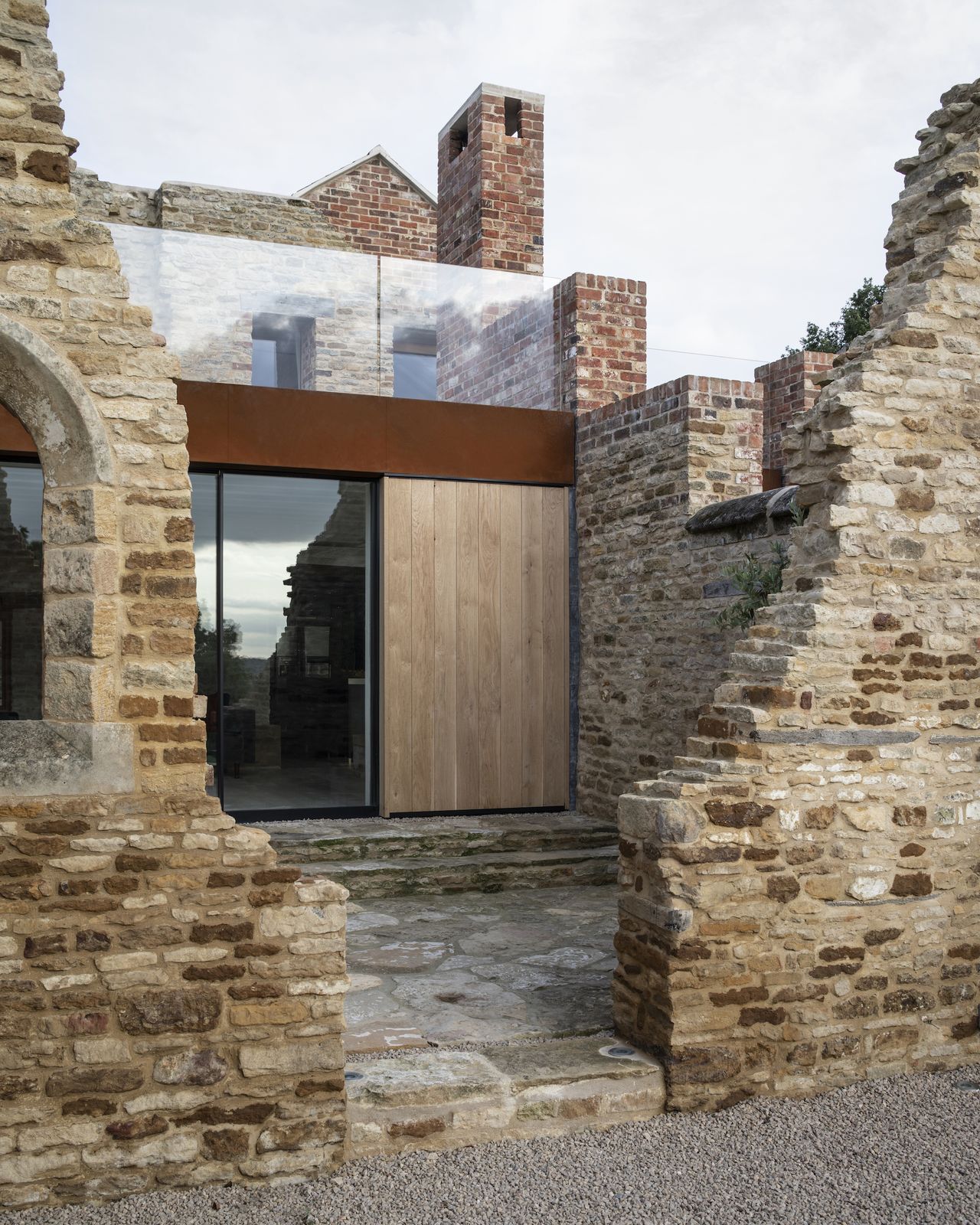 modern extension to cottage with stone ruins