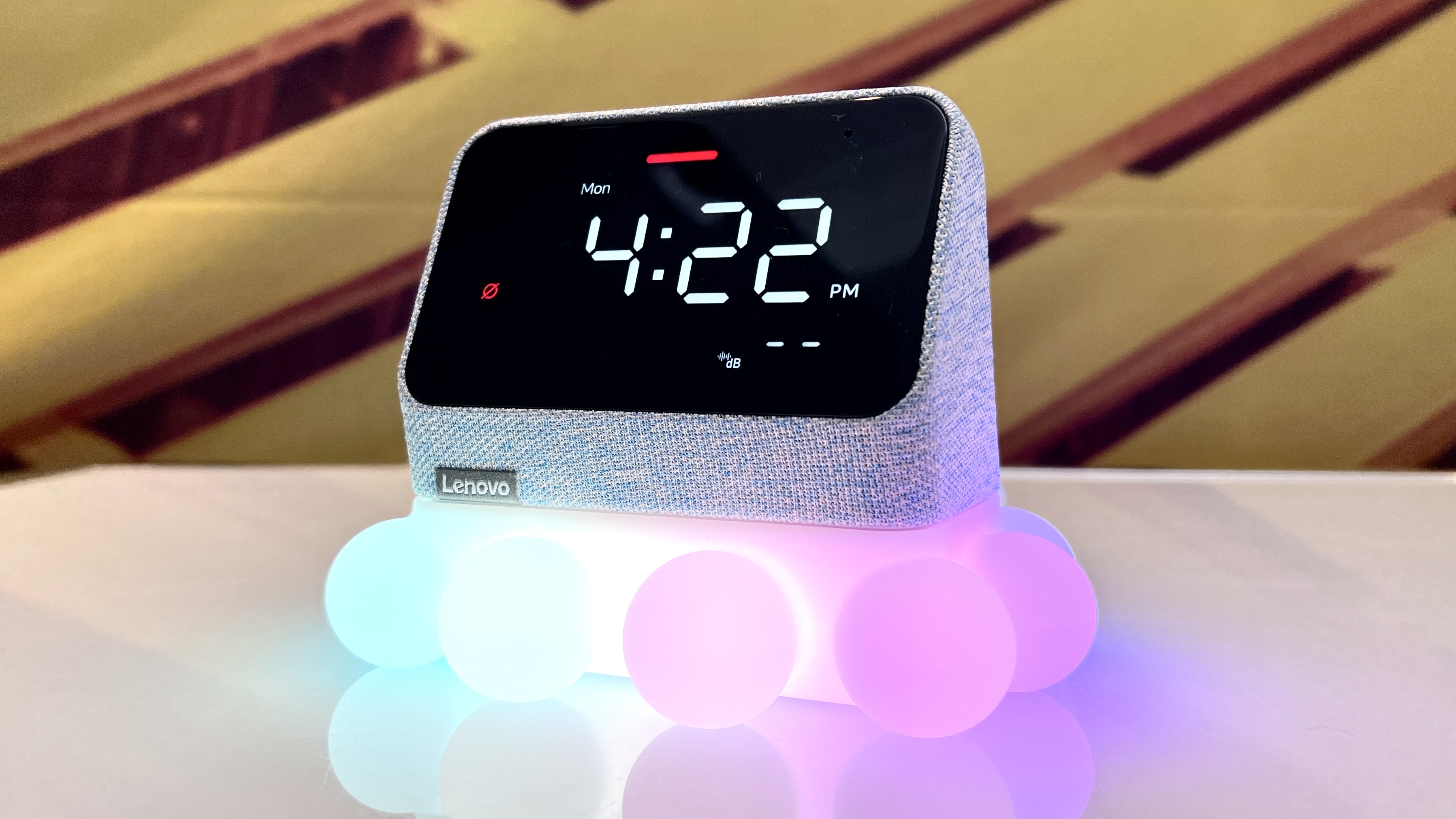 Lenovo Smart Clock Essential with Alexa plugged into a Lenovo Ambient Light Dock