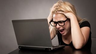 angry businesswoman working with a laptop at office