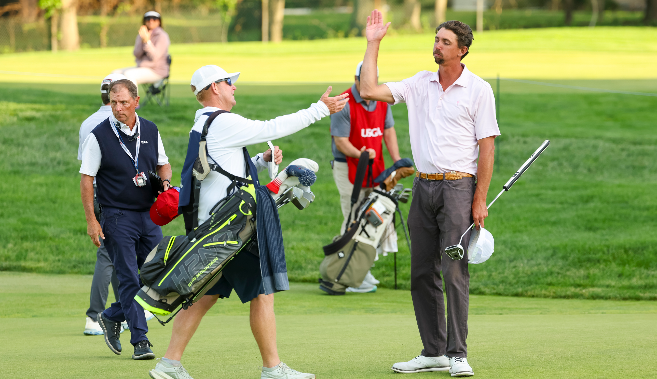 Marc Dull high fives his caddie