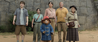 Brown family and Paddington Bear all standing together and looking concerned in Paddington In Peru