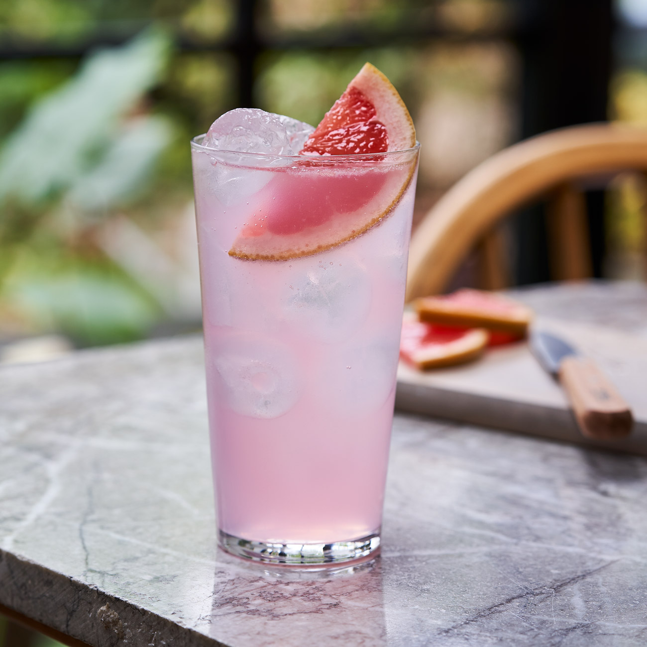 Pink cocktail in a highball glass