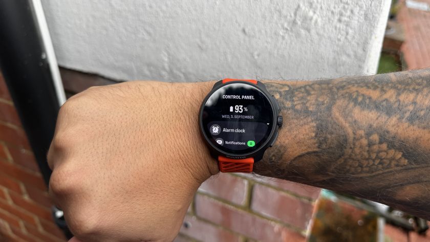 The Suunto Race 2 watch worn on a wrist displaying battery percentage 