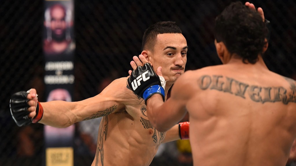 Max Holloway prepares to strike Charles Oliveira in their first UFC fight in 2015.