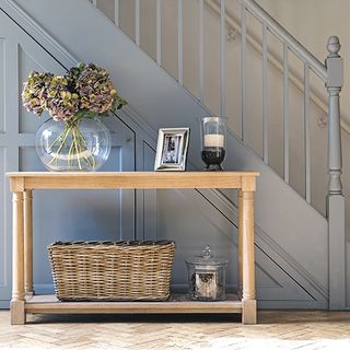grey staircase with cabins wooden desk with flower pot and wooden flooring