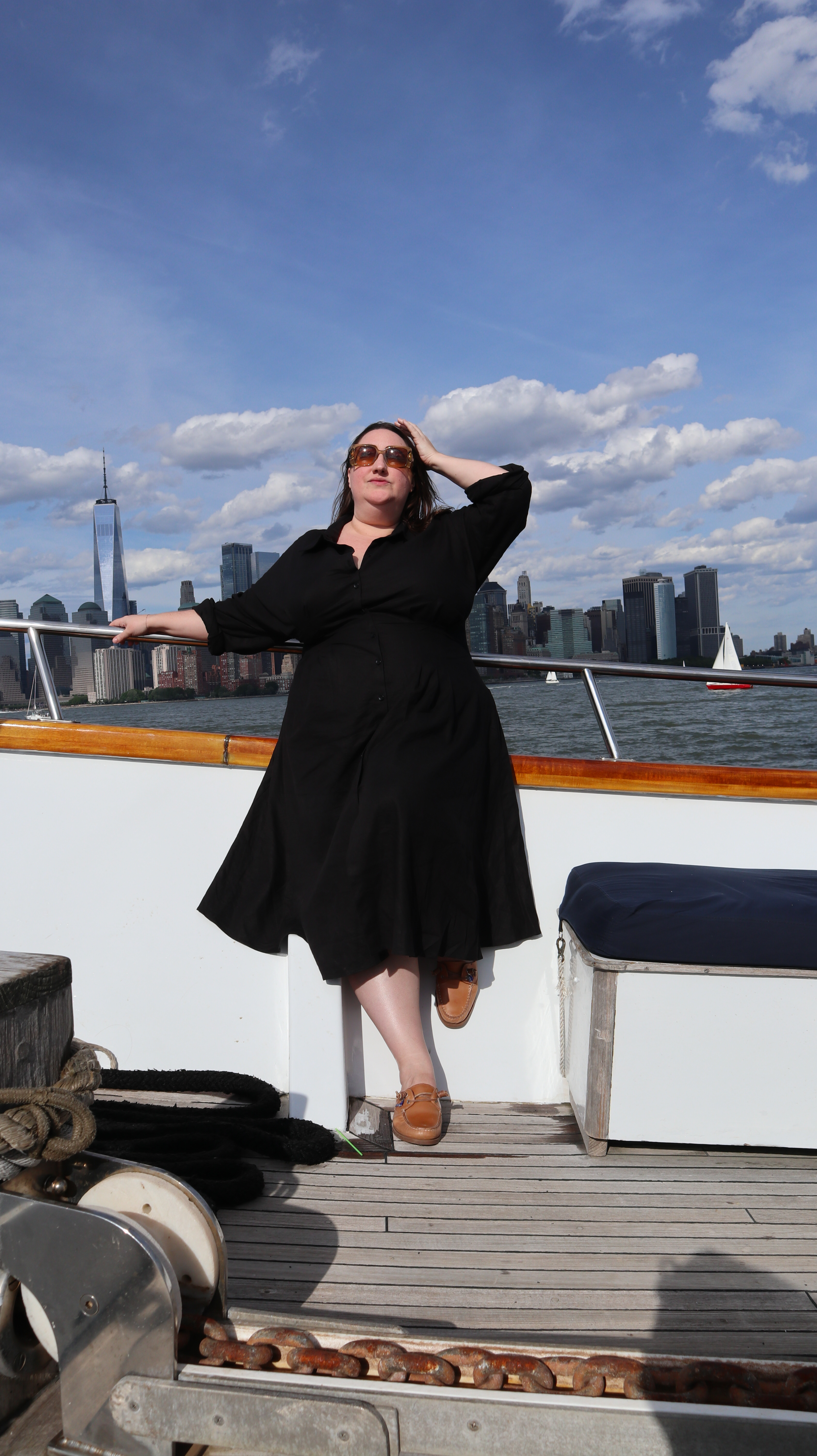Sarah Chiwaya styling a black linen dress with boat shoes