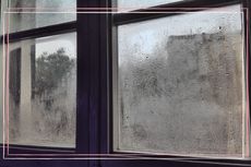 A steamed up window with condensation on it