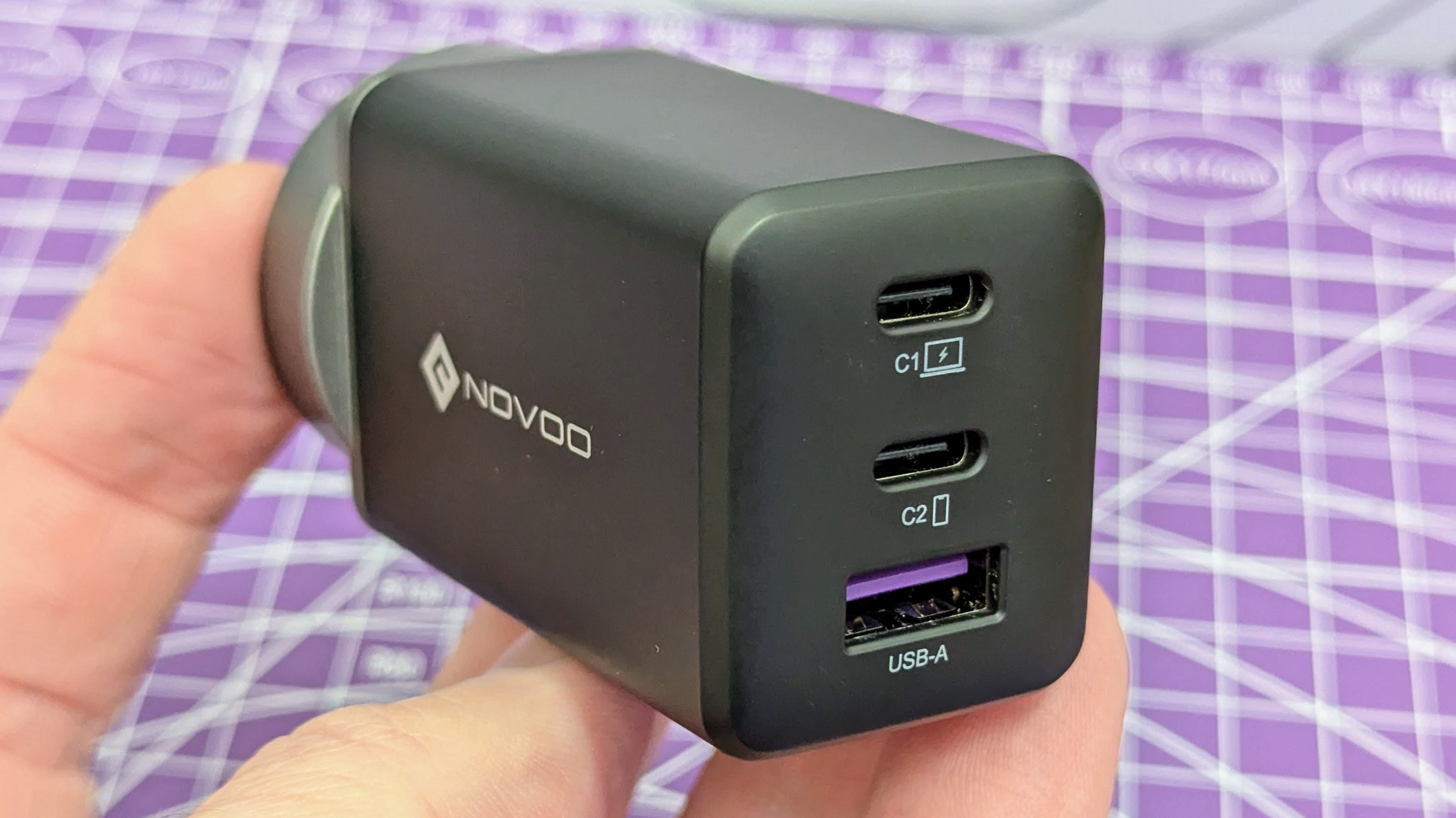 Novoo RG68 USB-C charger held by a hand