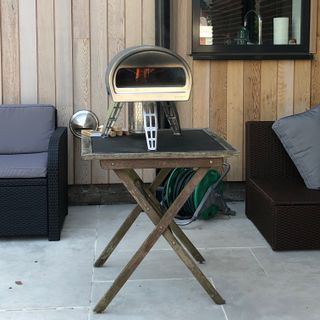 Roccbox pizza oven on a table in a garden