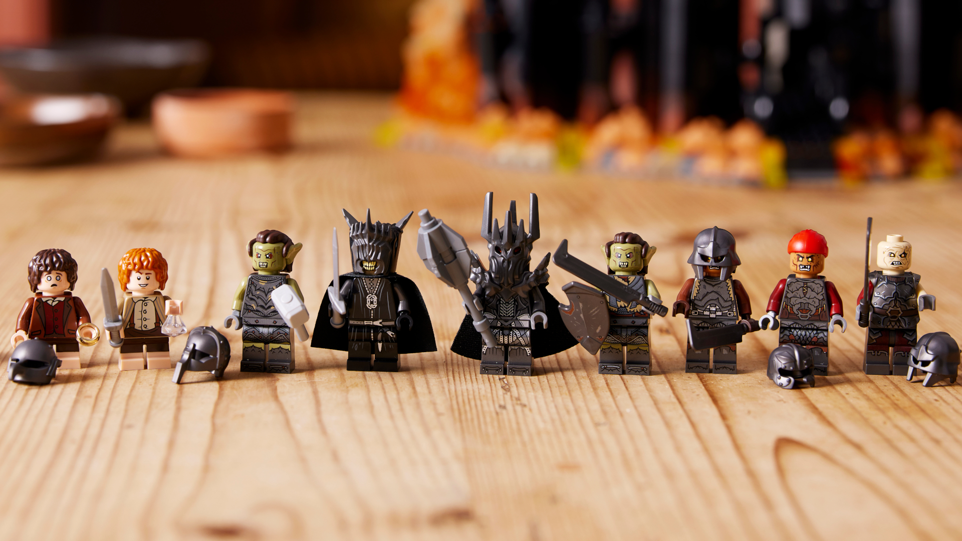 Minifigures from Lego Barad-dur laid out in a row on a wooden table