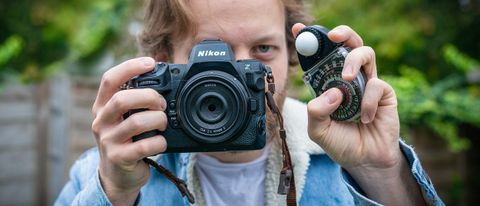 Sekonic Studio Deluxe III L-398A being held by man holding Nikon Z8