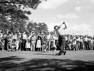 Sam Snead hitting a tee shot, watched by Ben Hogan