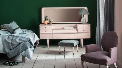bedroom with dressing table with drawers and a chair