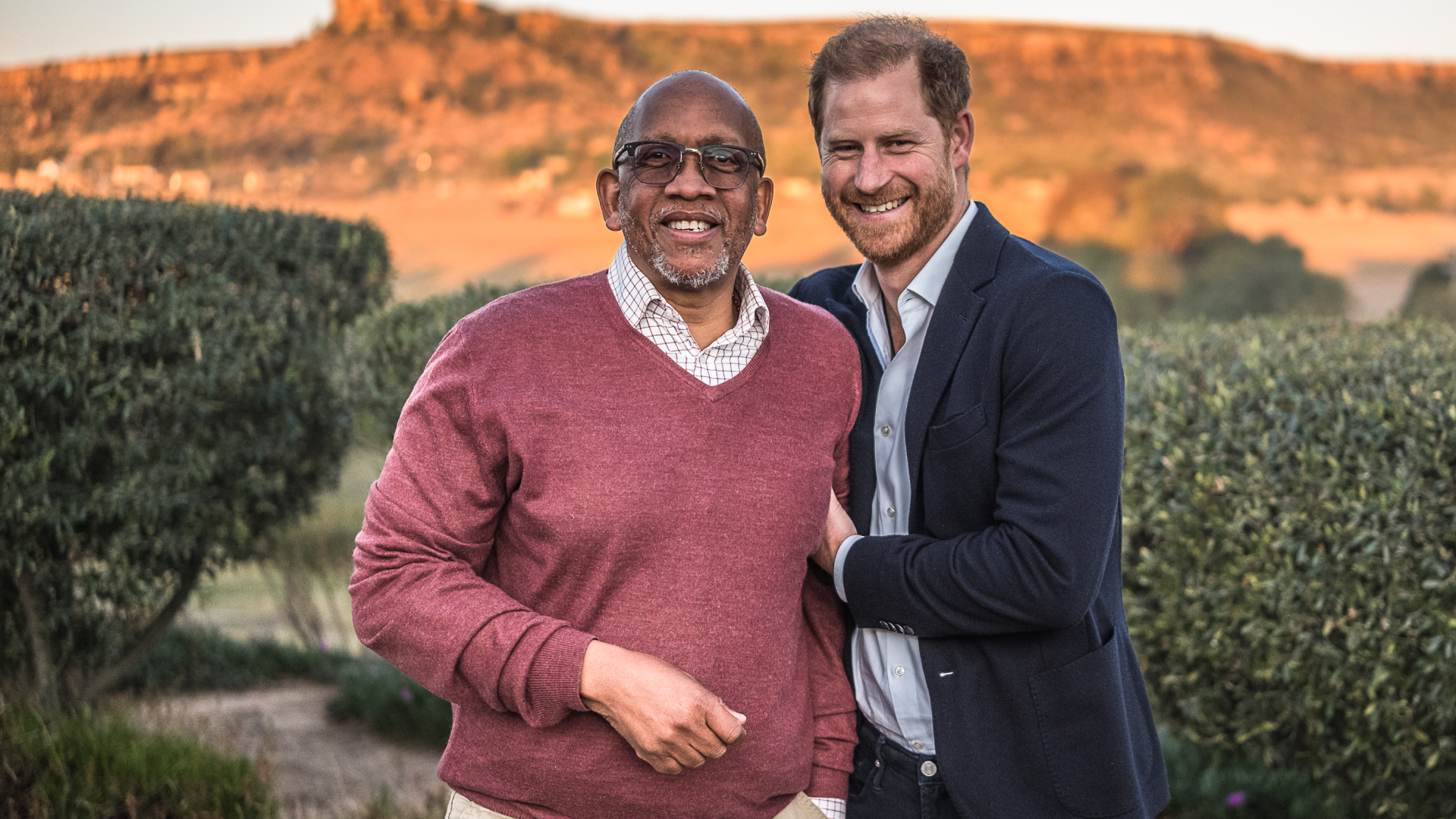 Prince Harry and Princes Seeiso posing in front of a mountain in Lesotho