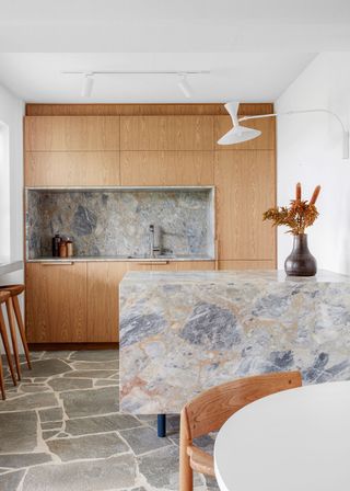 a kitchen with a swing arm lamp over a peninsula island