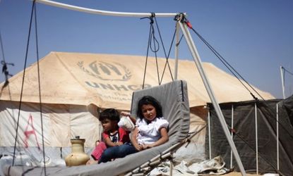 Two Syrian children lay on a handmade swing in front of their tent at the Zaatari Refugee Camp in Jordan on Sept. 2: The camp was originally built to hold 500 people. Now it has 26,000.